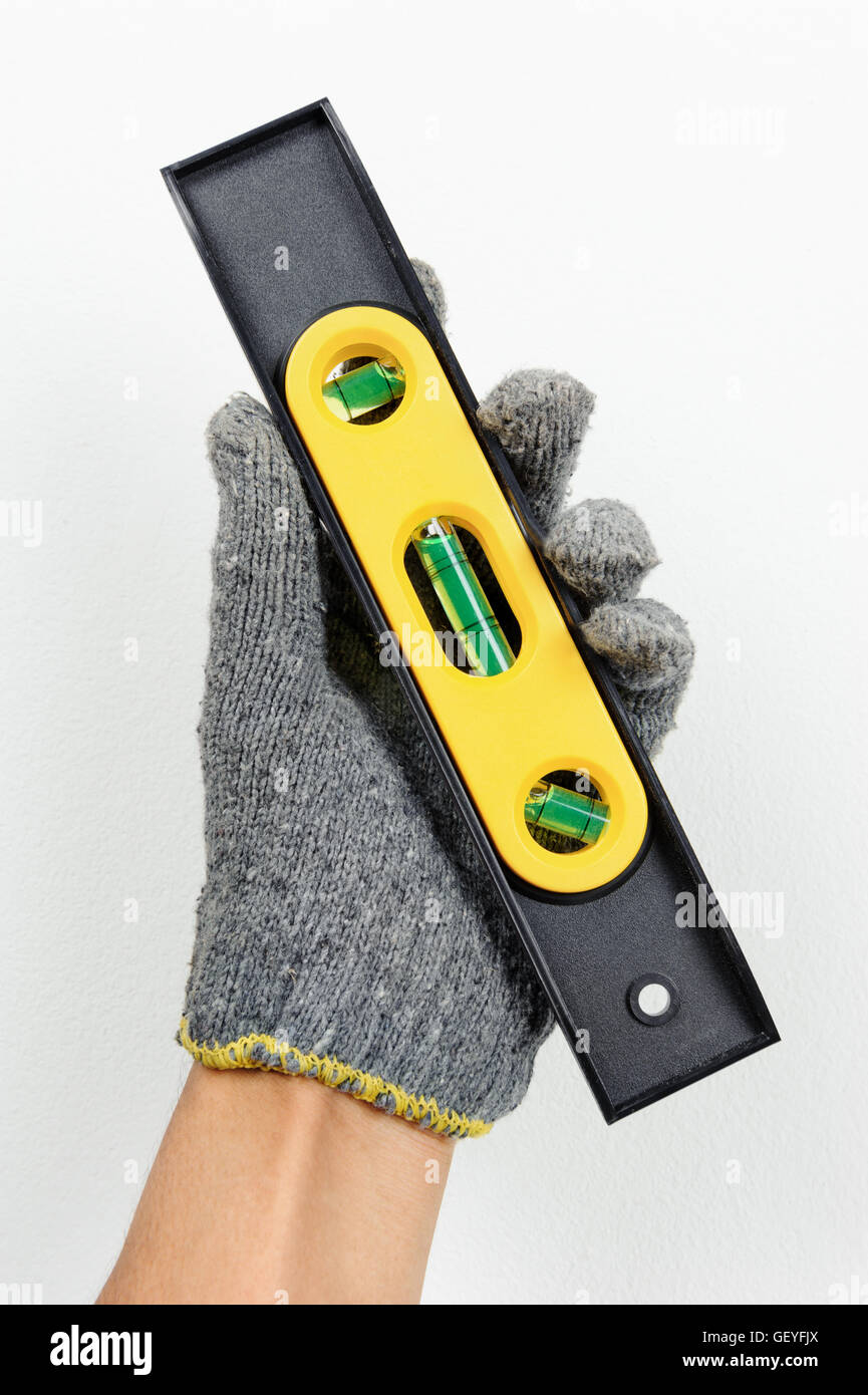 technician using spirit level to checking the level Stock Photo