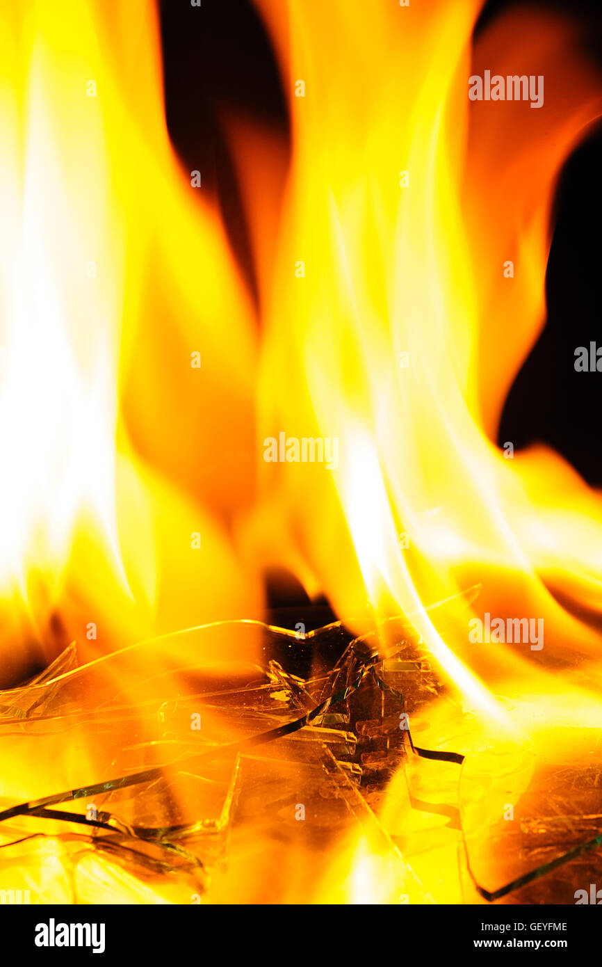 fire burning on cracked glass over black background Stock Photo Alamy