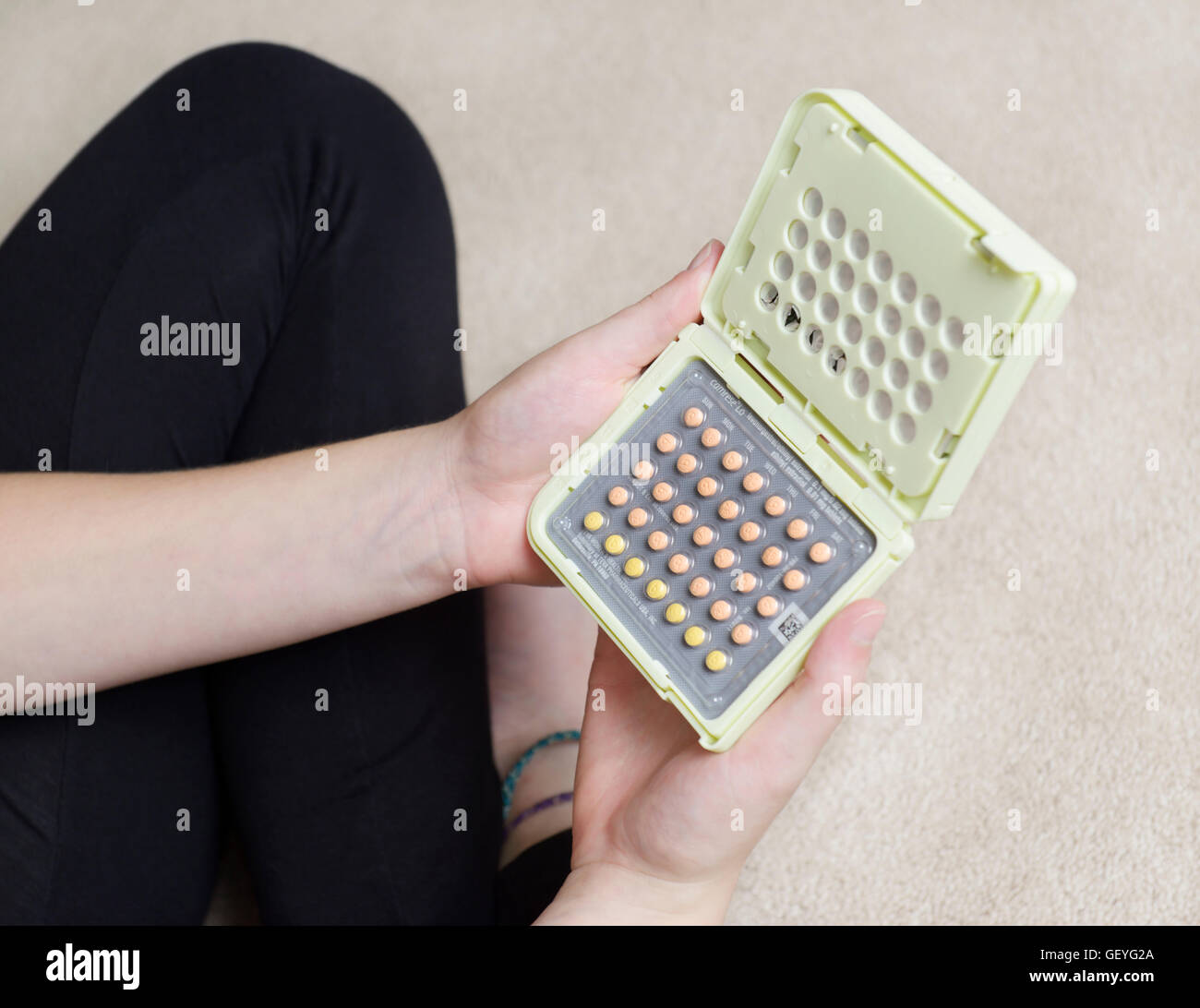 Teen girl holding birth control pills Stock Photo