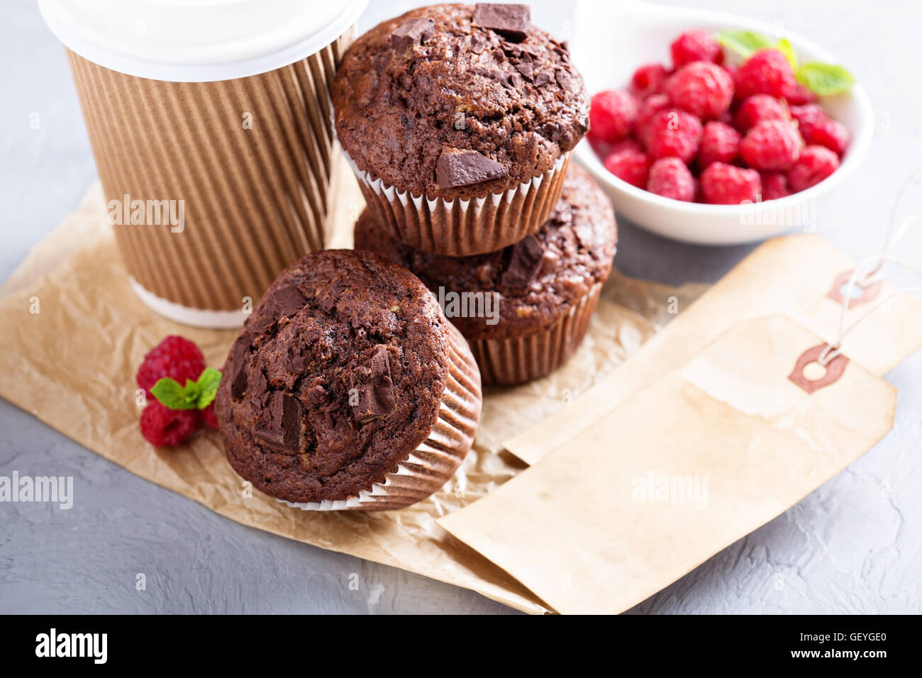 Chocolate muffins with coffee to go Stock Photo Alamy