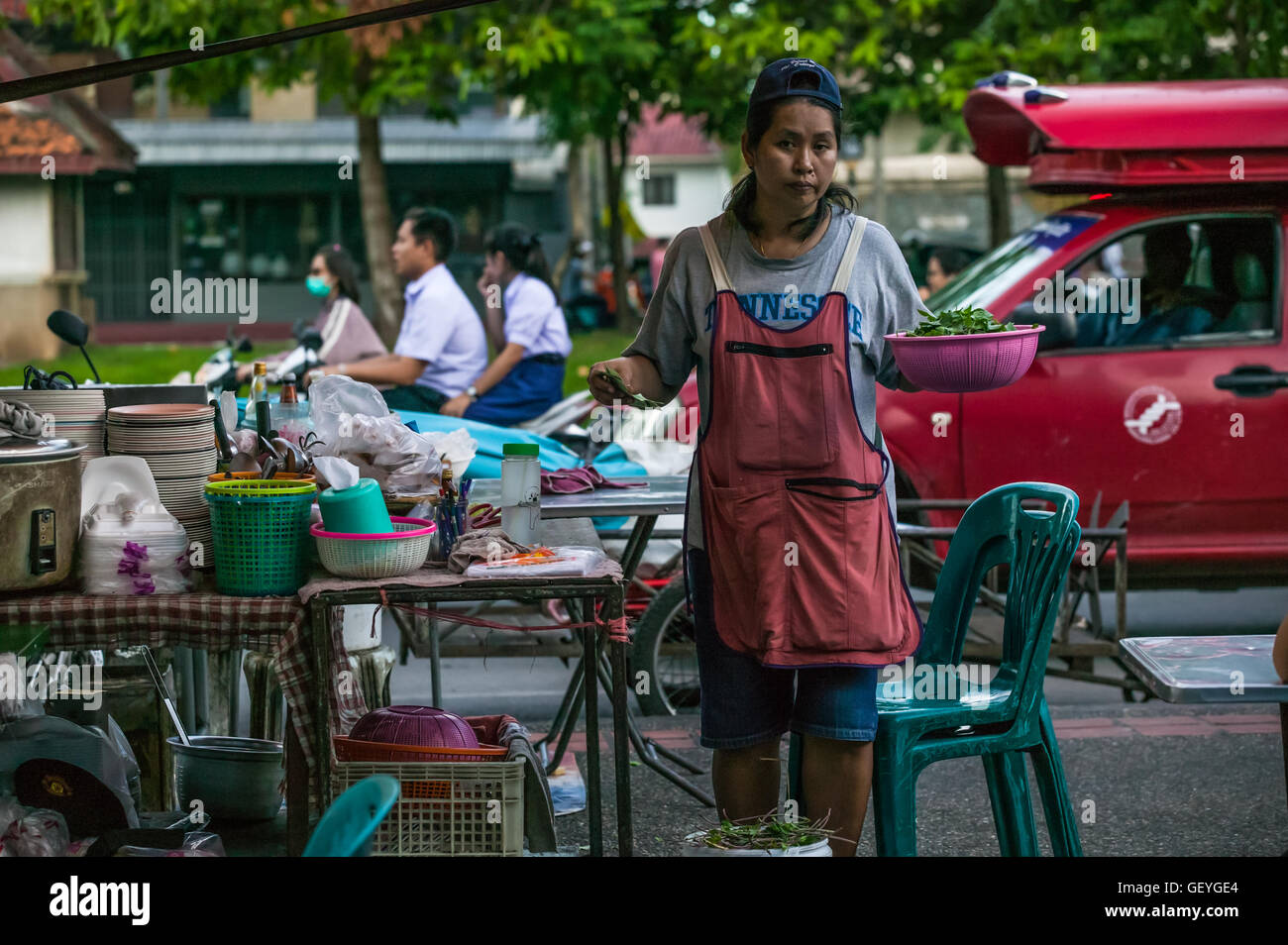 local Thai woman prepping vegetables,north gate food market,Chiang Mai Thailand Stock Photo