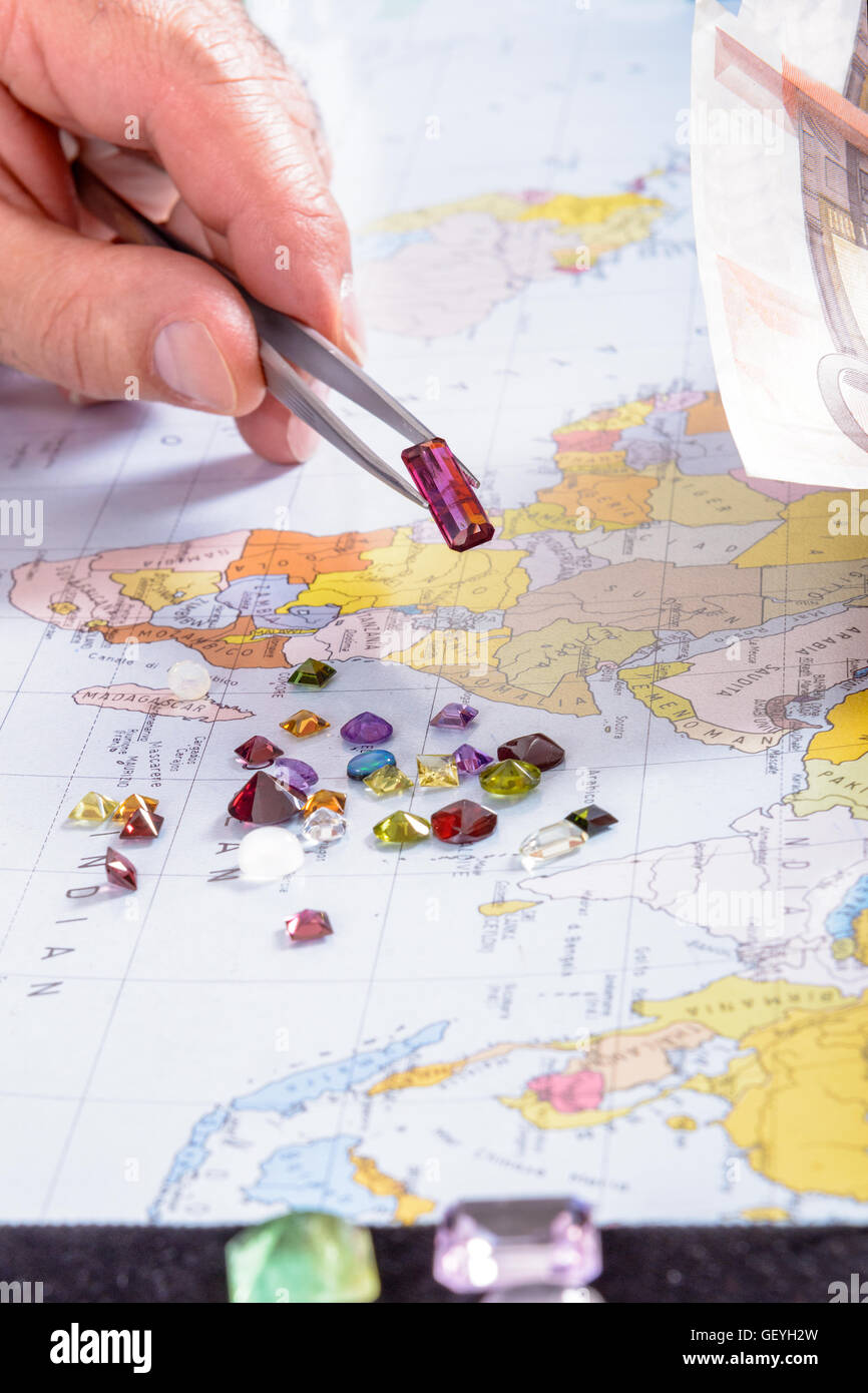 Dealer in precious stones do business on his desk. Payment gemstone in Euro. Stock Photo