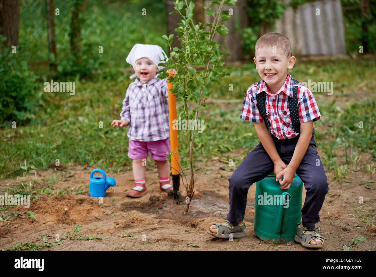funny boy with shovel in garden Stock Photo - Alamy