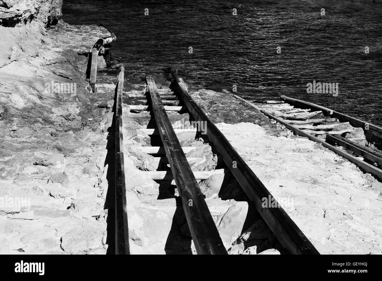 Black and white images of boat tracks into the sea Stock Photo