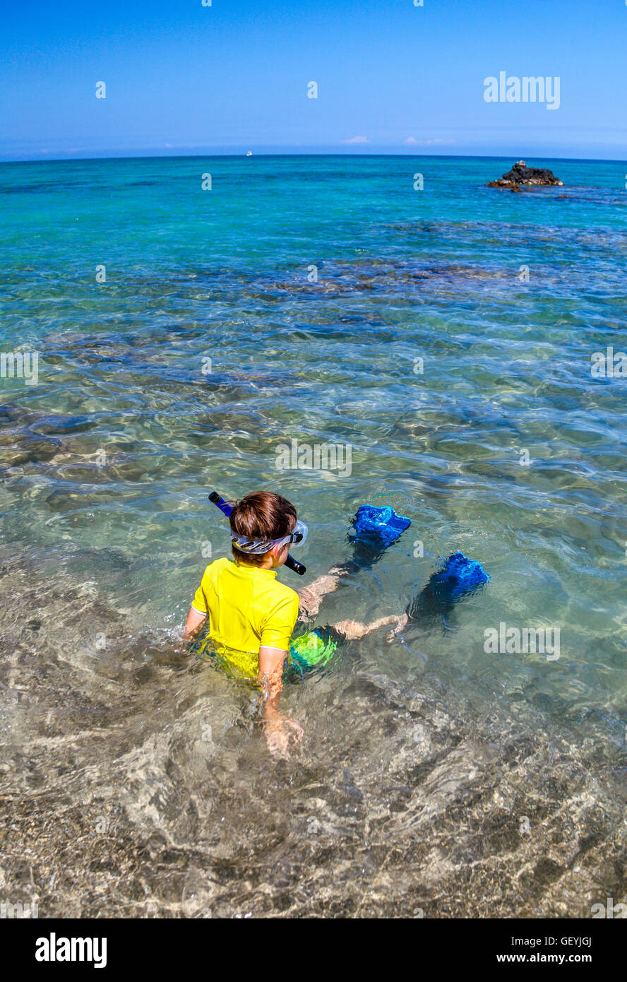 Boy with snorkeling gear at Anaehoomalu Bay in Waikoloa on the Big