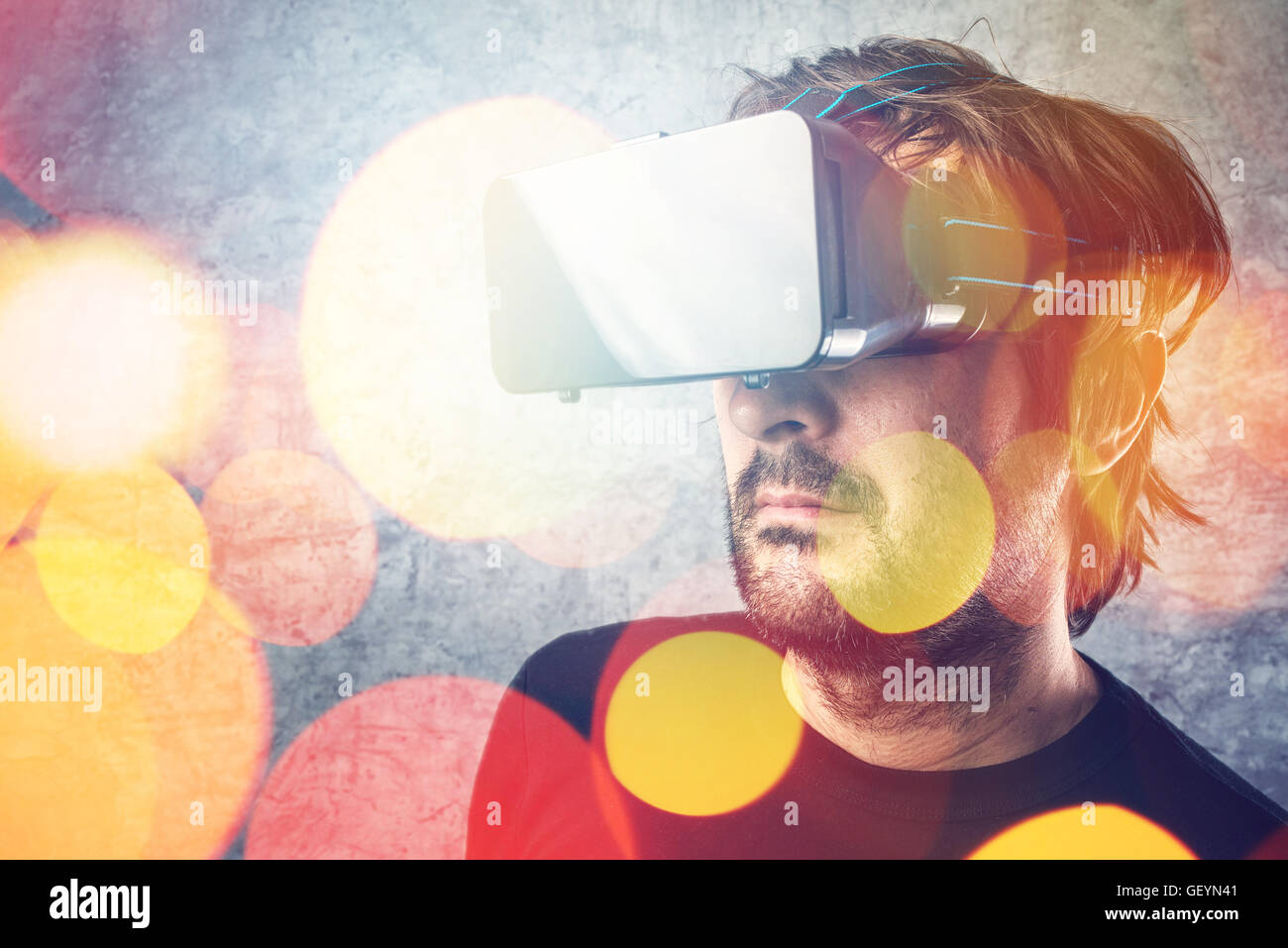 Adult man wearing virtual reality goggles and watching 3D VR multimedia