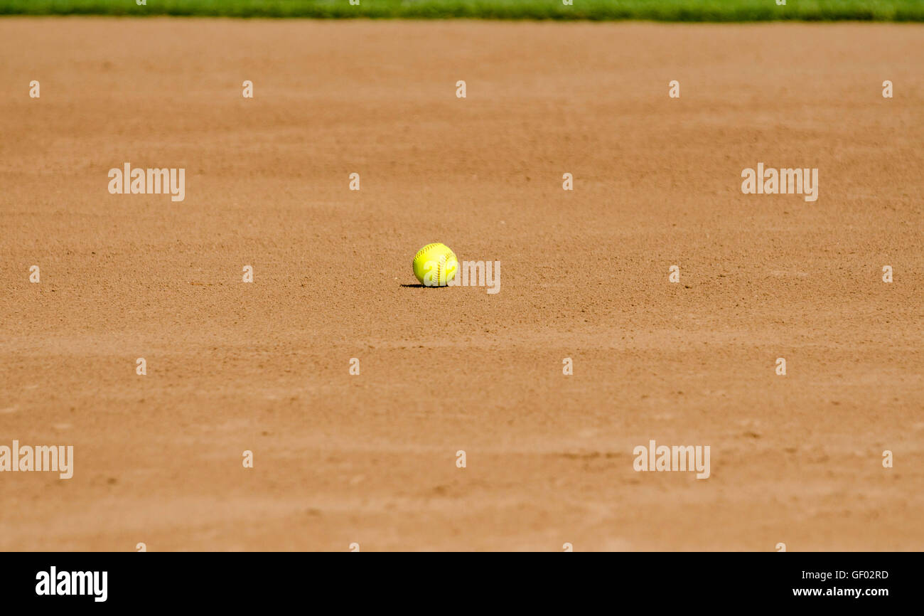 Yellow softball on field Stock Photo