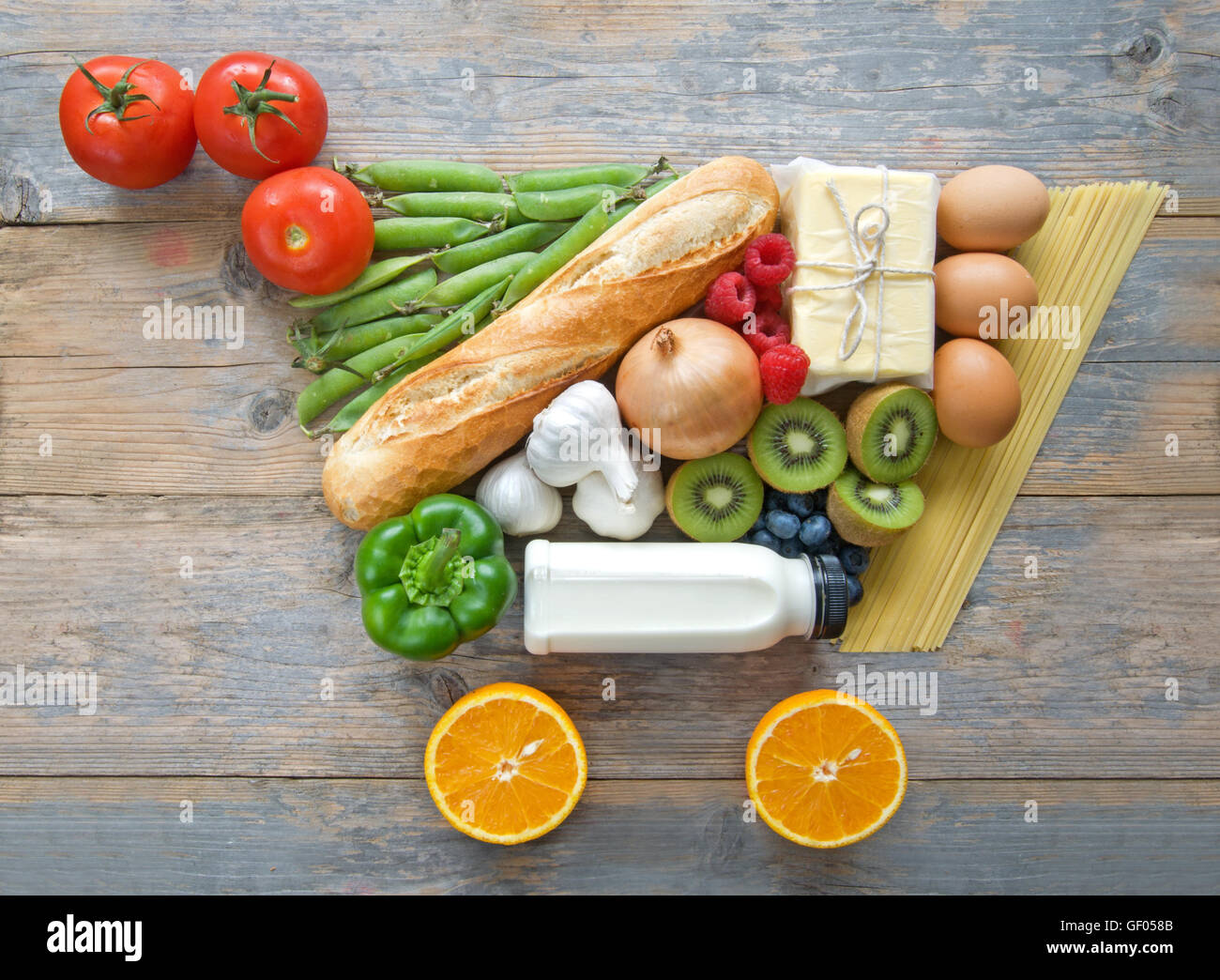 Fruits, vegetables, pasta and dairy products in the shape of a grocery