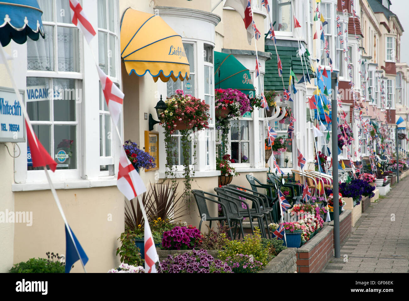 Bed and breakfasts and hotels, decorating with flags, buntings and flowers on the Esplanade, Weymouth Dorset UK Stock Photo