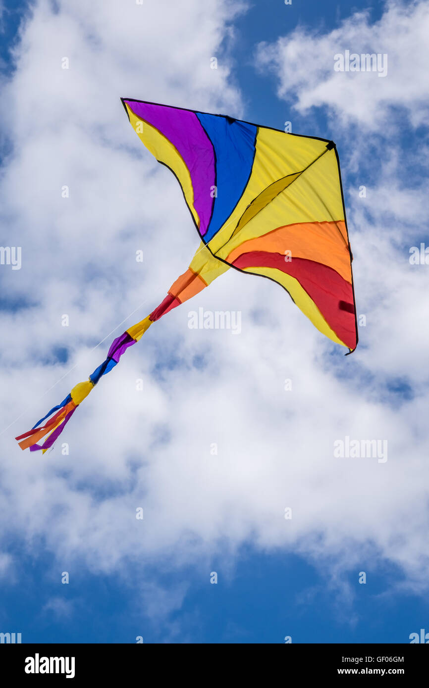 Colourful Kite Flying High In The Sky On A Kite Day Stock Photo