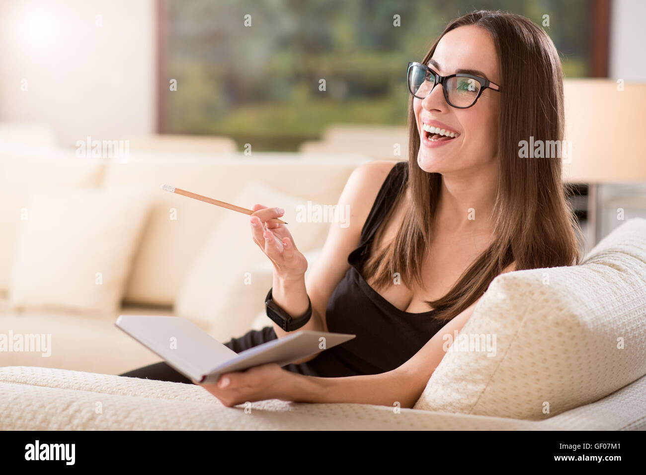 Woman looking aside and holding diary Stock Photo