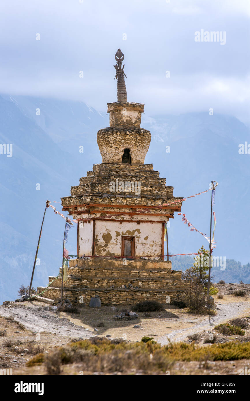 Traditional old Buddhist stupa in mountains of Nepal. Annapurna Circuit Trek Stock Photo