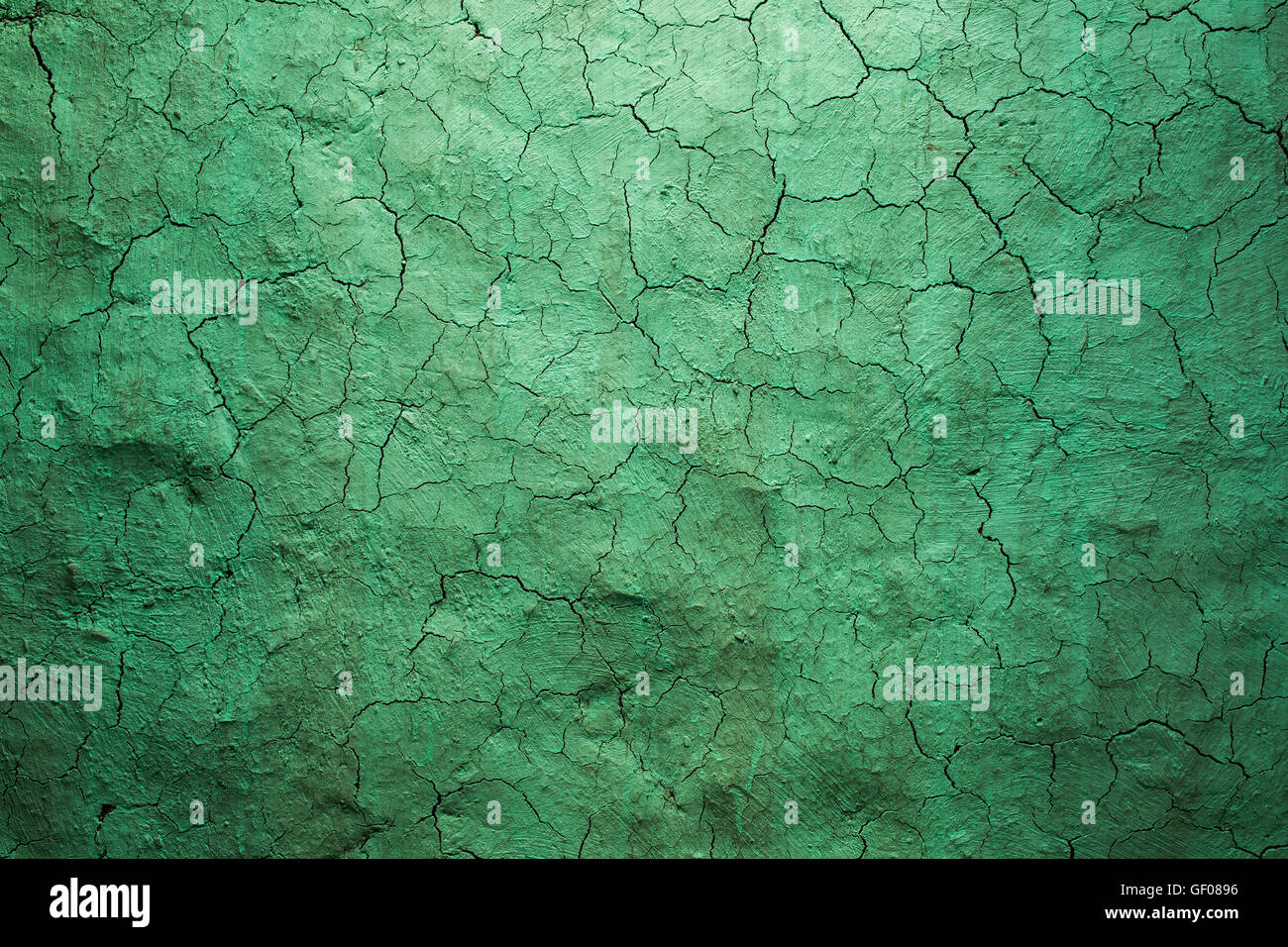 Old texture green cracked wall, the old paint texture is chipping and cracked fall destruction. Grunge wall texture for design. Stock Photo