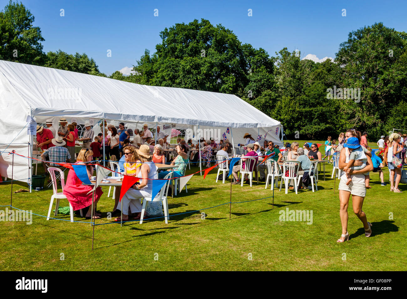People Eating Cakes and Drinking Tea Outside A Marquee, Withyham Fete, Withyham, Sussex, UK Stock Photo