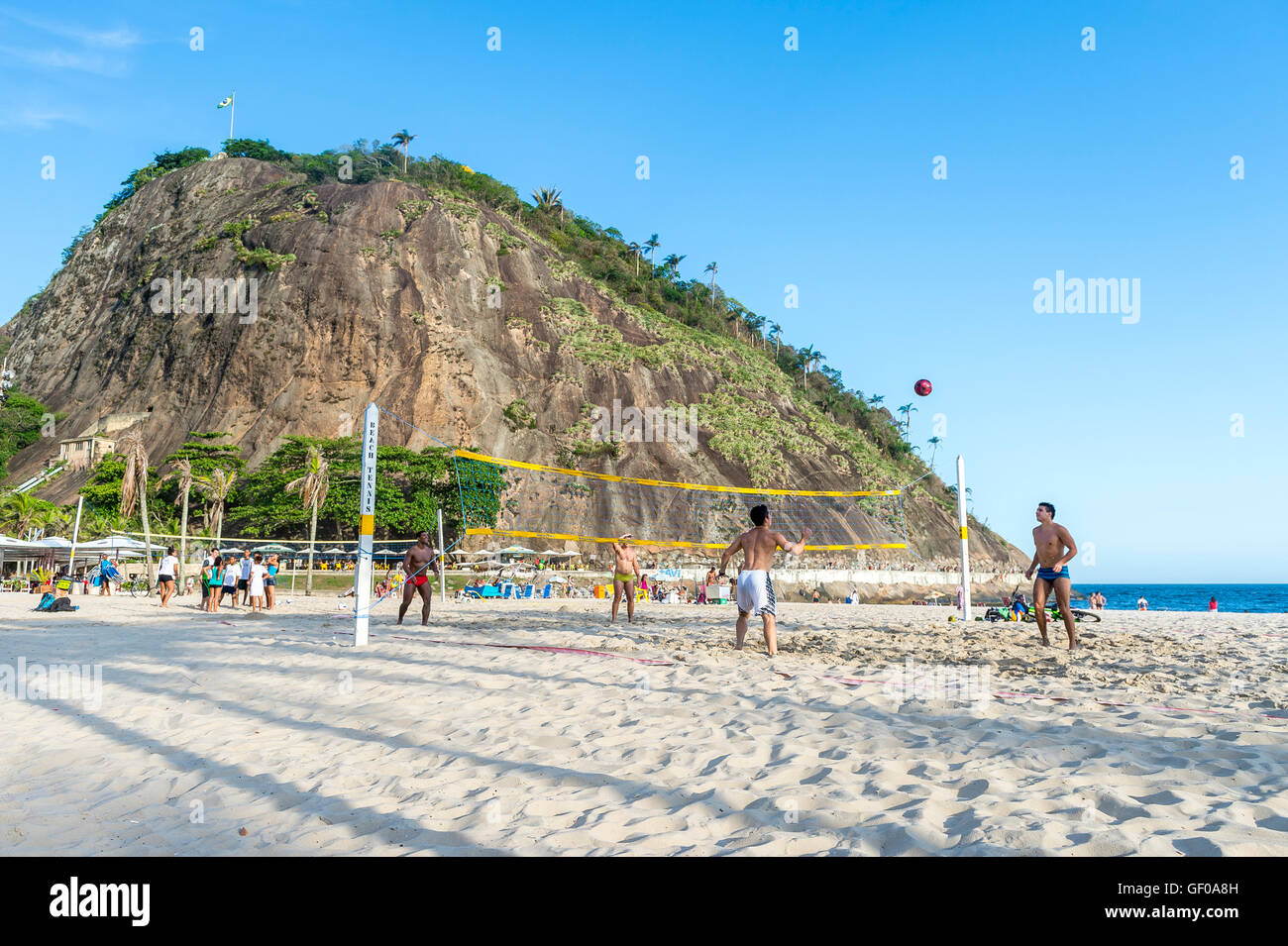 RIO DE JANEIRO - FEBRUARY 10, 2015: Young Brazilian men play a game of footvolley, a sport that combines football and volleyball Stock Photo