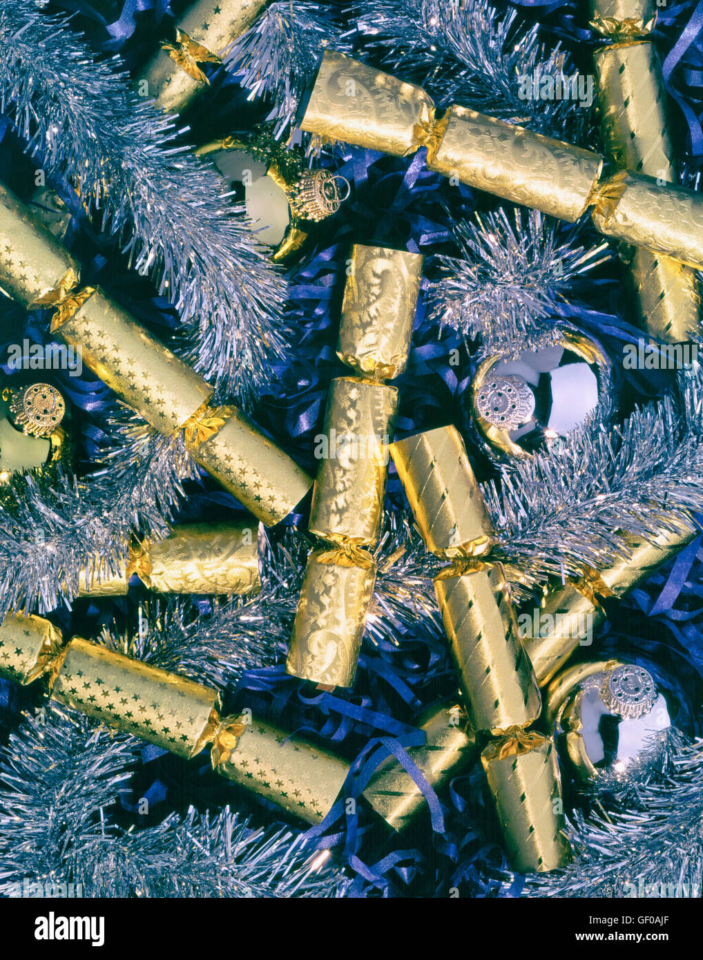 Christmas crackers in box with tinsel and glass balls Stock Photo