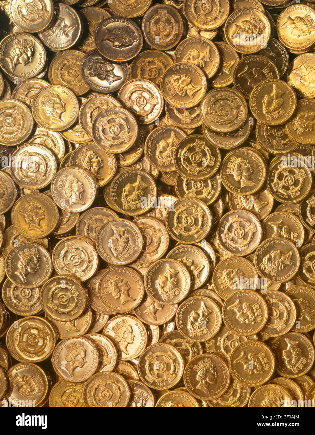 Many pound coins stacked on top of one another Stock Photo