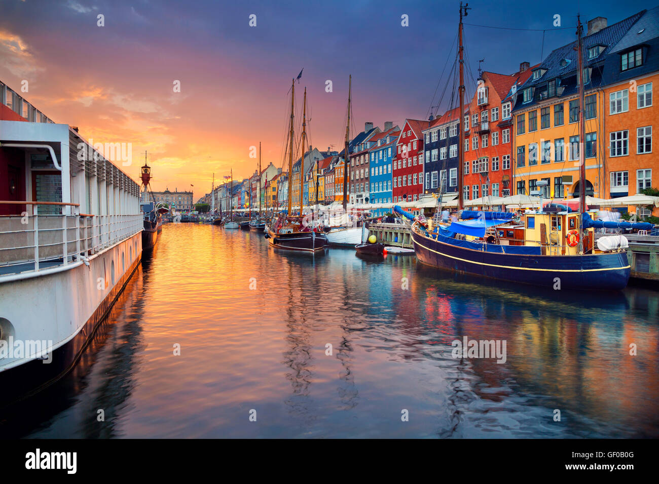 Copenhagen, Nyhavn Canal. Image of Nyhavn Canal in Copenhagen, Denmark during beautiful sunset. Stock Photo