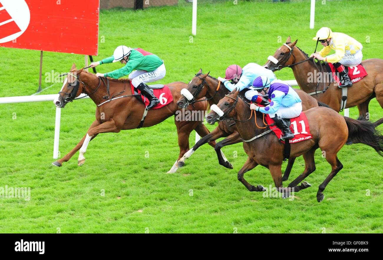 Millefiori ridden by Shane Foley (left) beats Cairdiuil ridden by G Carroll (right) and Lady Fandango ridden by D P McDonogh (centre) to win TheTote.com Handicap during day three of the Galway Festival in Ballybrit, Ireland. Stock Photo