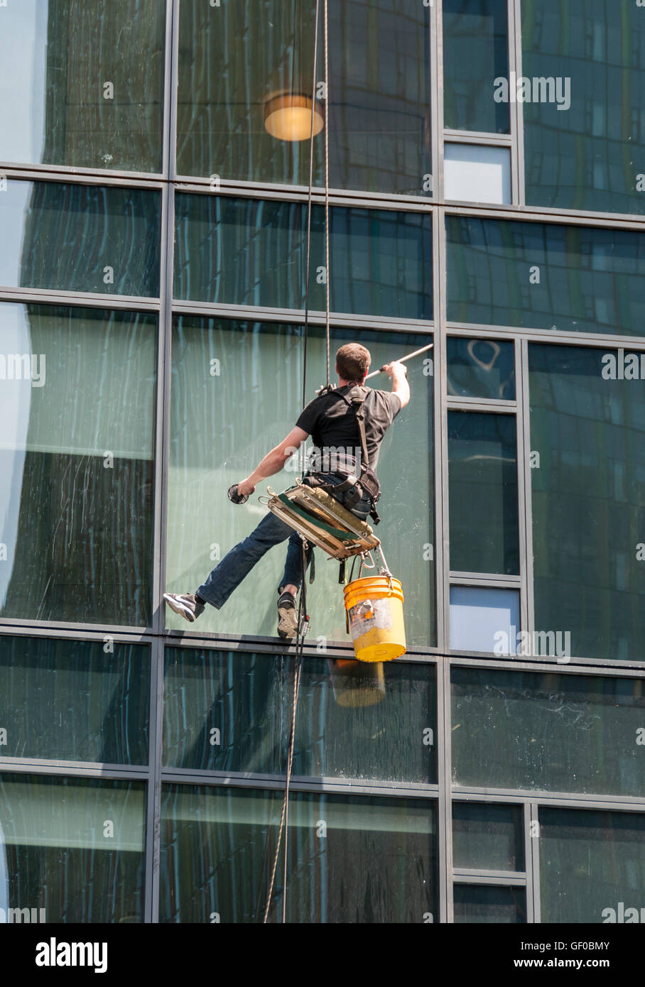 Washing windows of a building Stock Photo