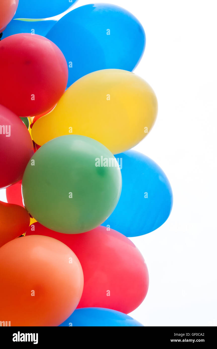 Colored party balloons against white background Stock Photo - Alamy