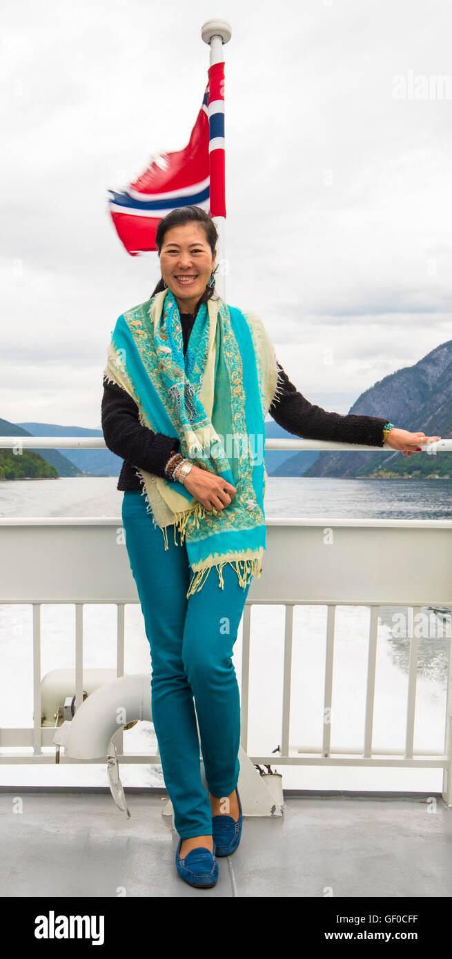 Happy passenger posing for a picture on the Express Passenger Boat, Sognefjord tours, Norway, Scandanavia, European. Stock Photo