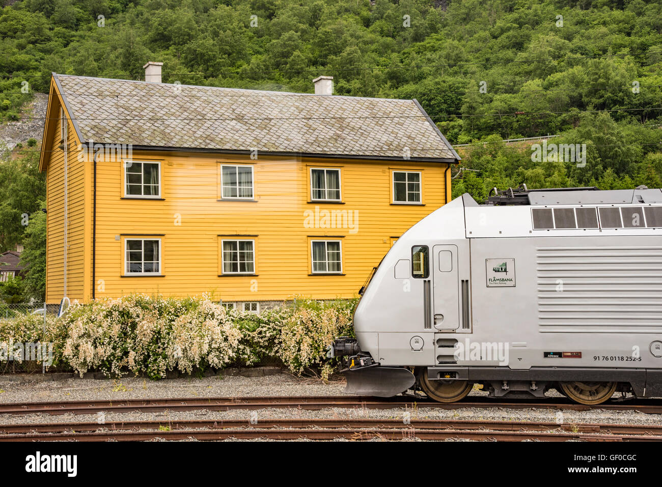 Flam train and bright yellow building on tracks, Flam, Norway, Scandanavia, European Stock Photo