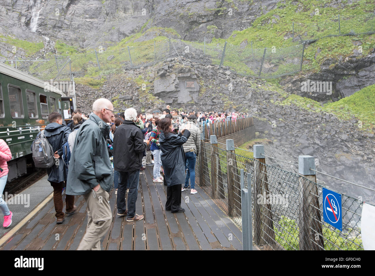 Tourists taking pictures of Kjosfossen Waterfalls from Flam Train bridge, Flam, Norway, Scandanavia, European Stock Photo