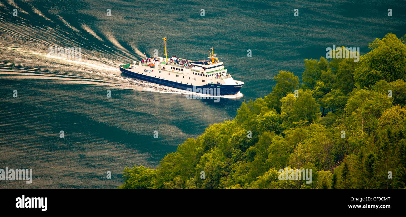 View of Geiranger Fiord Passenger Express Ferry navigating in blue water toward Ferry Dock, Alesund, Norway, Scandanavia, Stock Photo