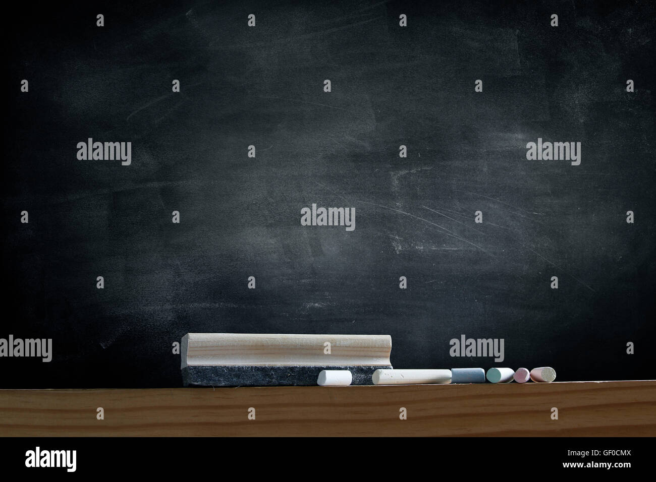Duster and chalk in front of blackboard Stock Photo Alamy