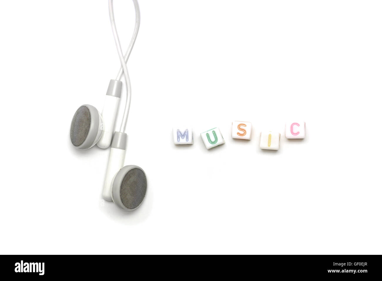 white earbuds with alphabet music on cube shape Stock Photo