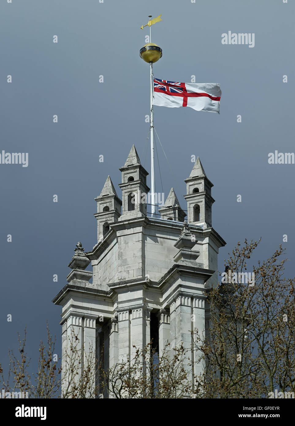 St Anne's Limehouse tower pinnacles & White Ensign; by Nicholas Hawksmoor 1714-27. Stock Photo