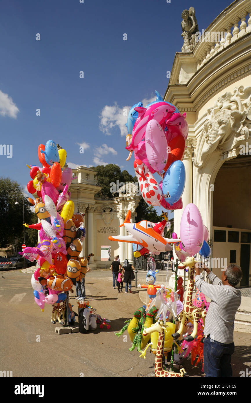 Balloon sellers and tourists at the entrance to the Giardino Zoologico or Zoological Gardens, Villa Borghese, Rome, Italy. Stock Photo