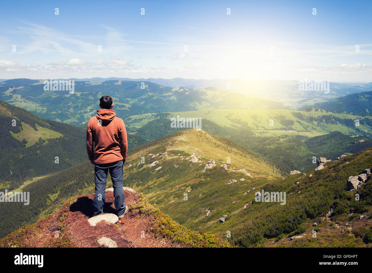 Man standing on the top of the mountain Stock Photo - Alamy
