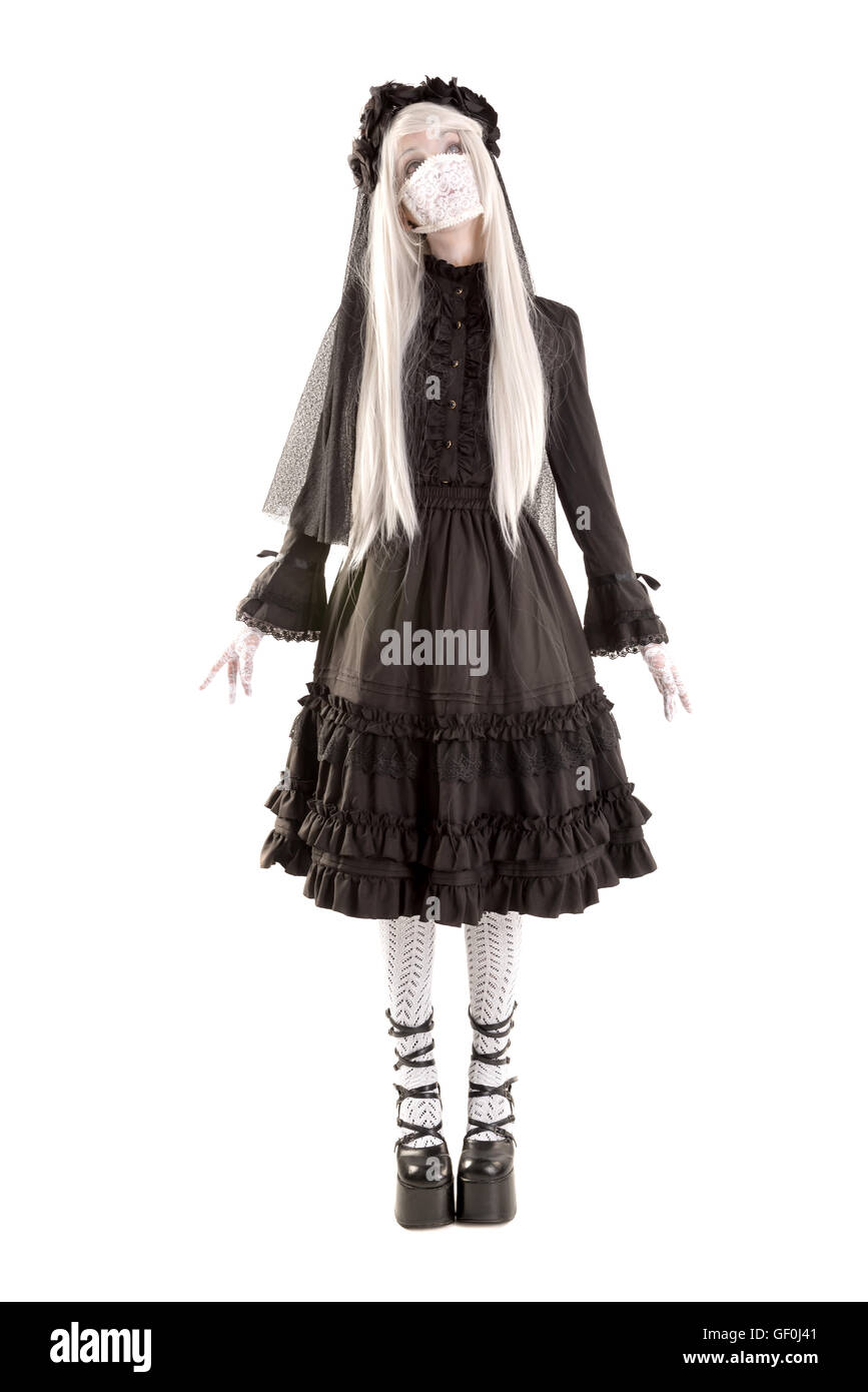 Widow in a black dress with white eyes looking like a doll isolated in white Stock Photo