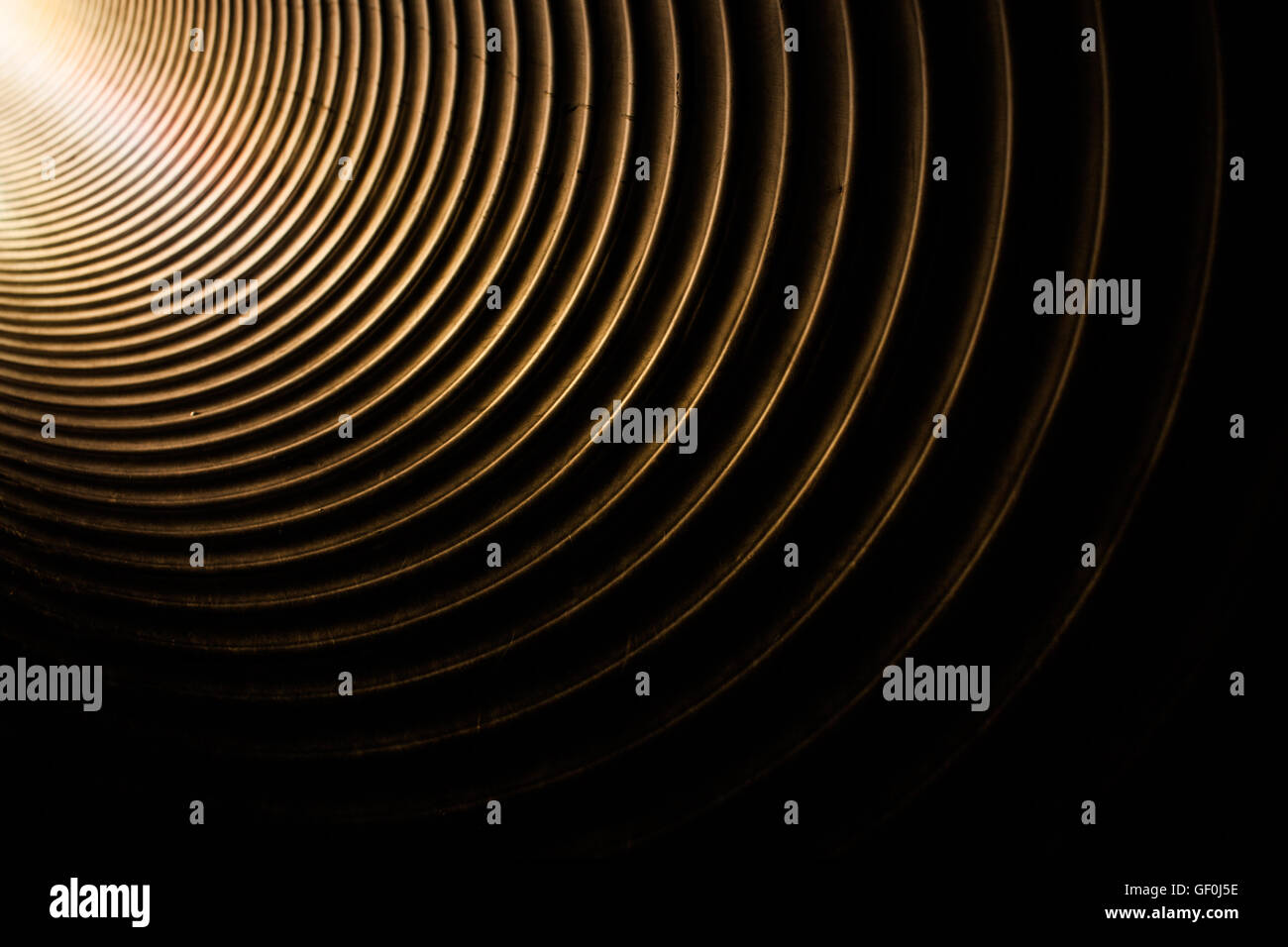 Light getting into the large metal tunnel pipe on a kids playground