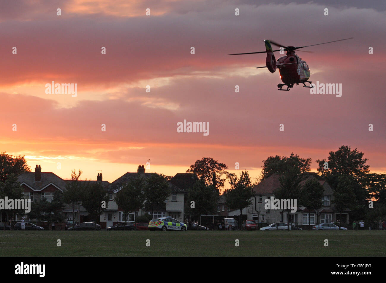 Thames Valley Air Ambulance taking off into sunset Stock Photo