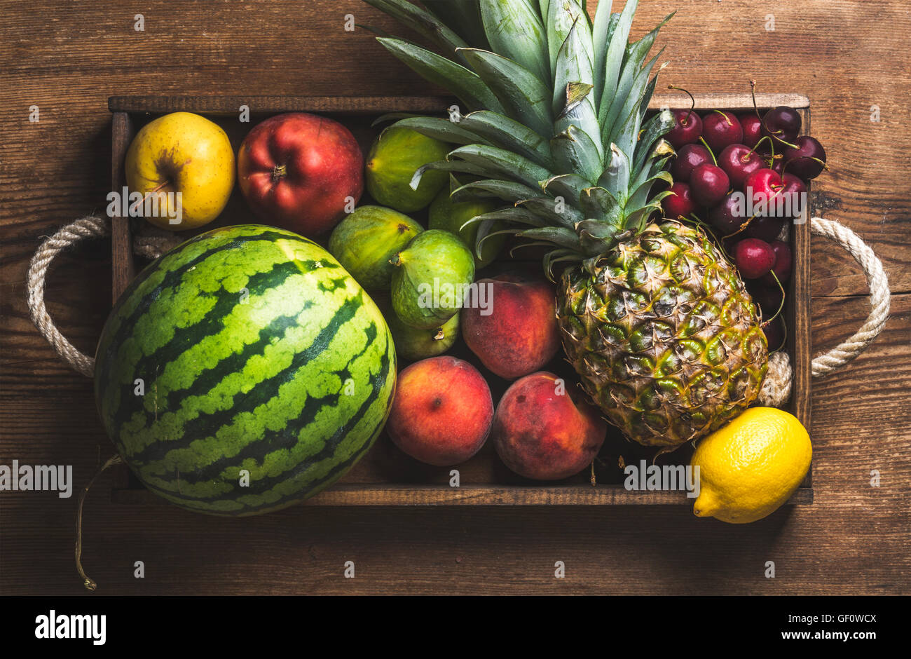Top Friut Summer friut variety in wooden tray over dark rustic background Stock ...