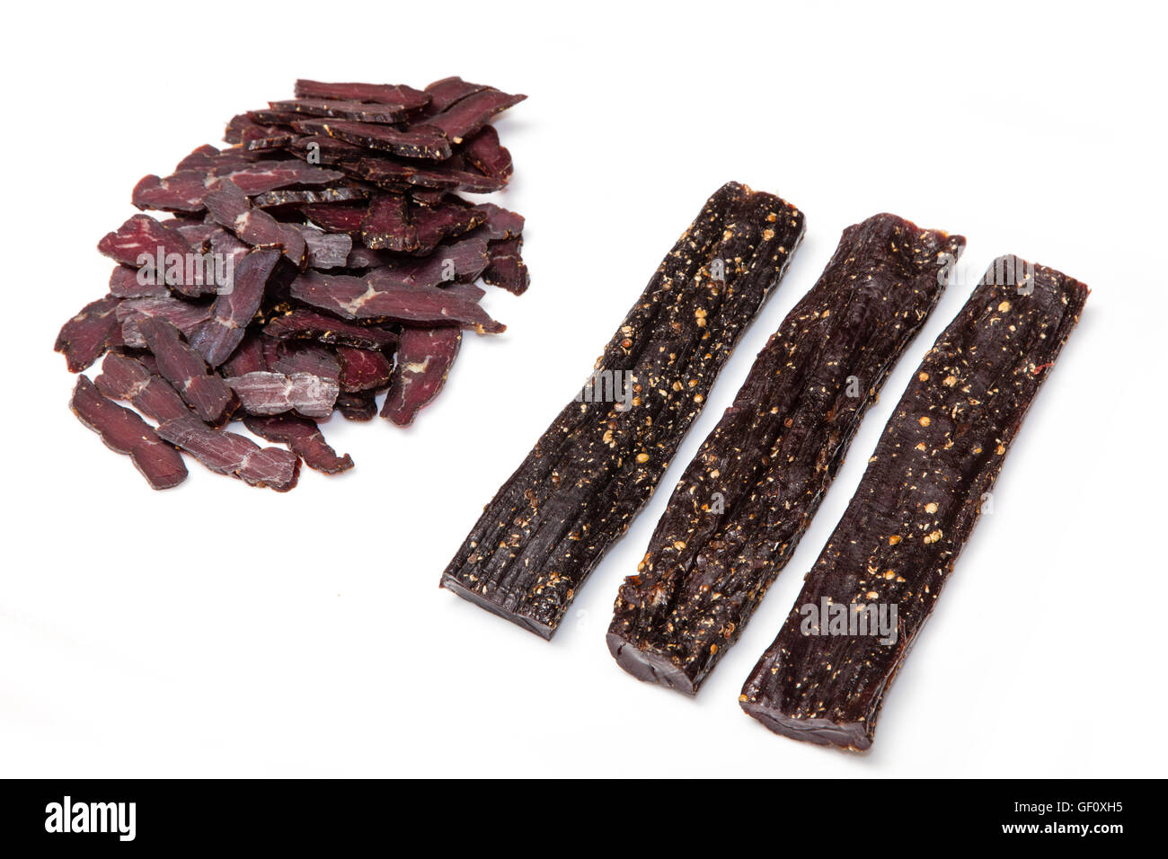 South African beef biltong or jerky whole and sliced isolated on a white studio background. Stock Photo