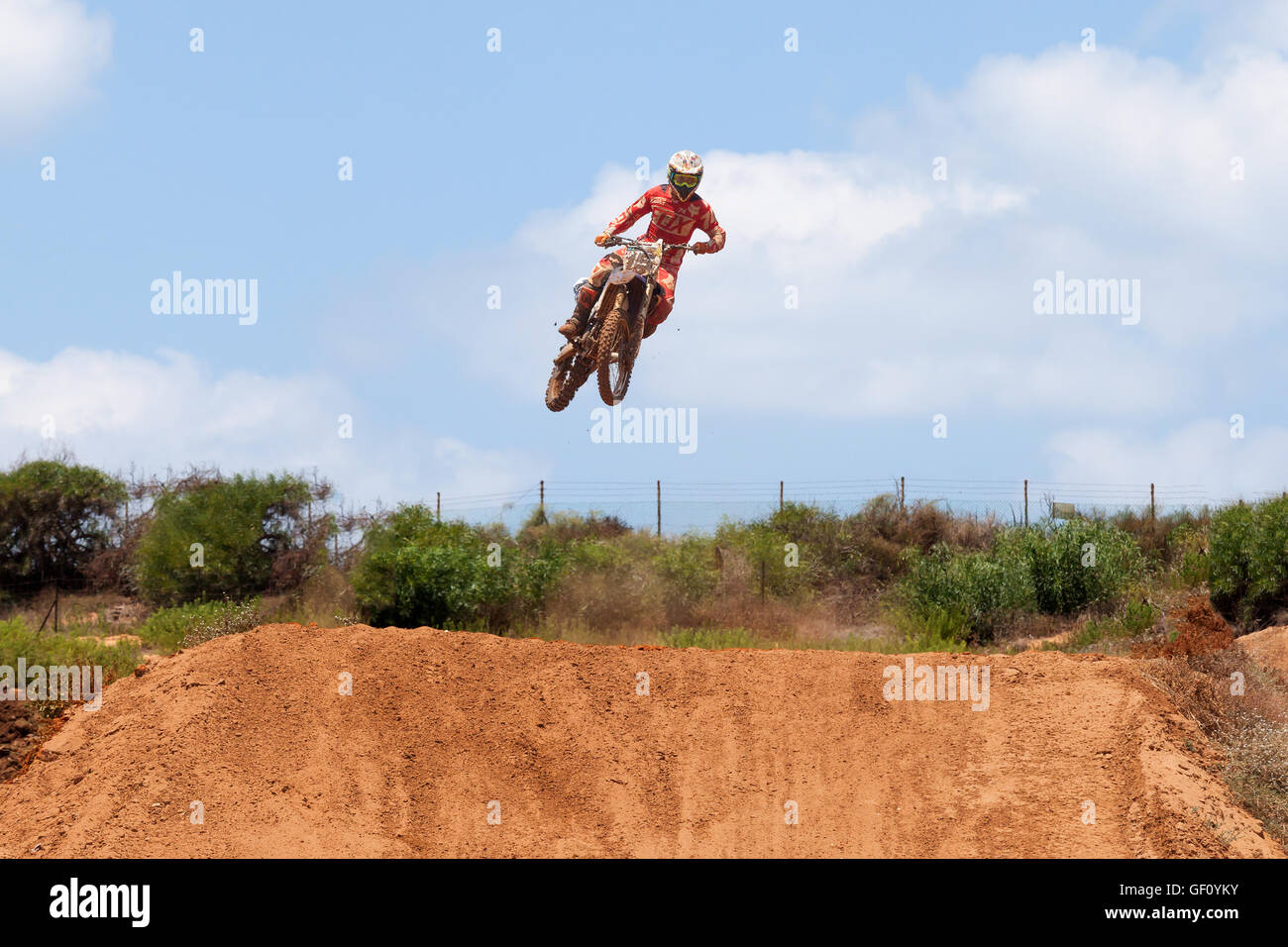 Motocross rider and bike clearing a tabletop jump during the final heat