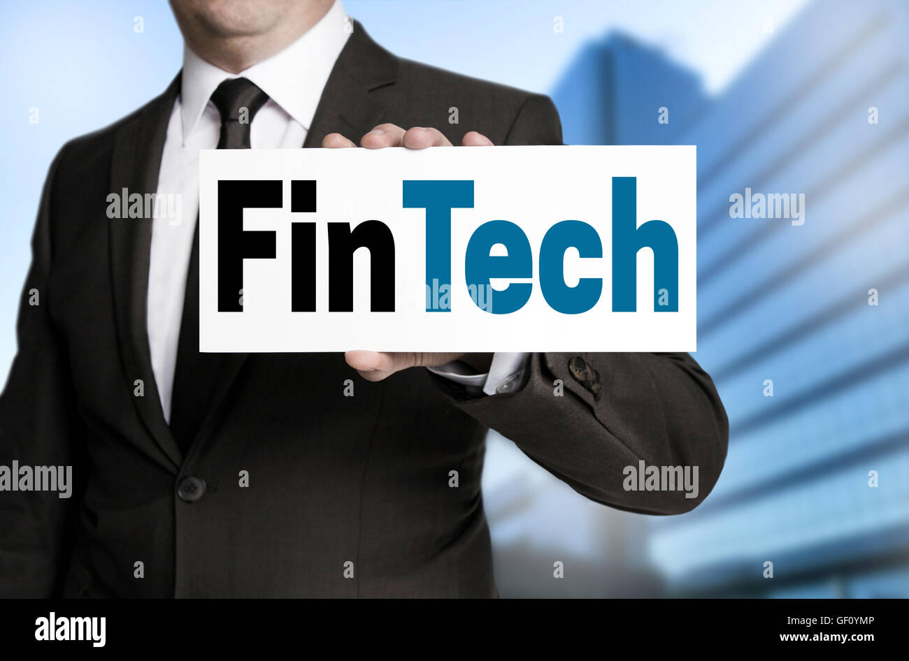 FinTech sign is held by businessman. Stock Photo