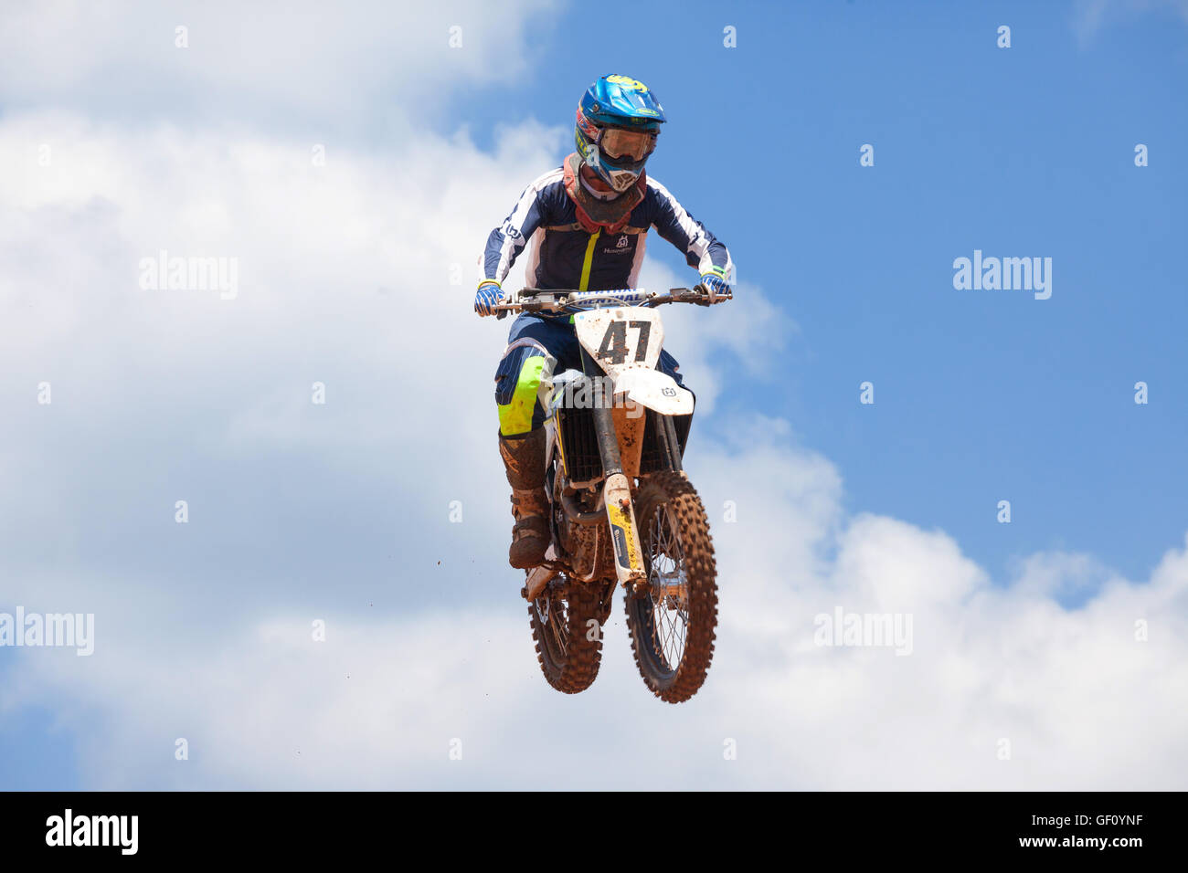 Motocross rider and bike clearing a tabletop jump during the final heat of the race Stock Photo