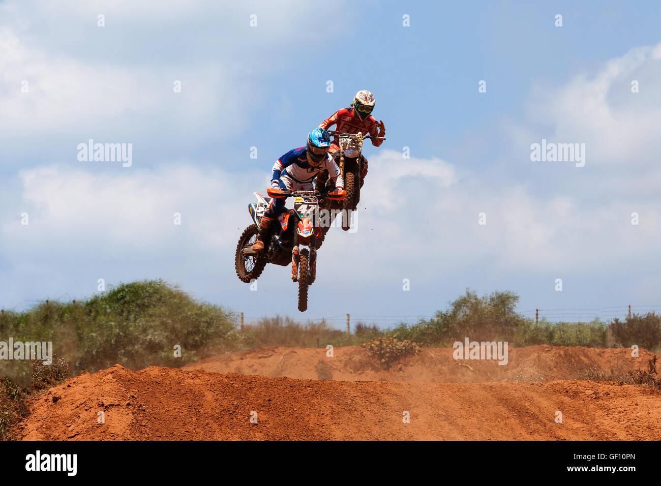 Motocross rider and bike clearing a tabletop jump during the final heat