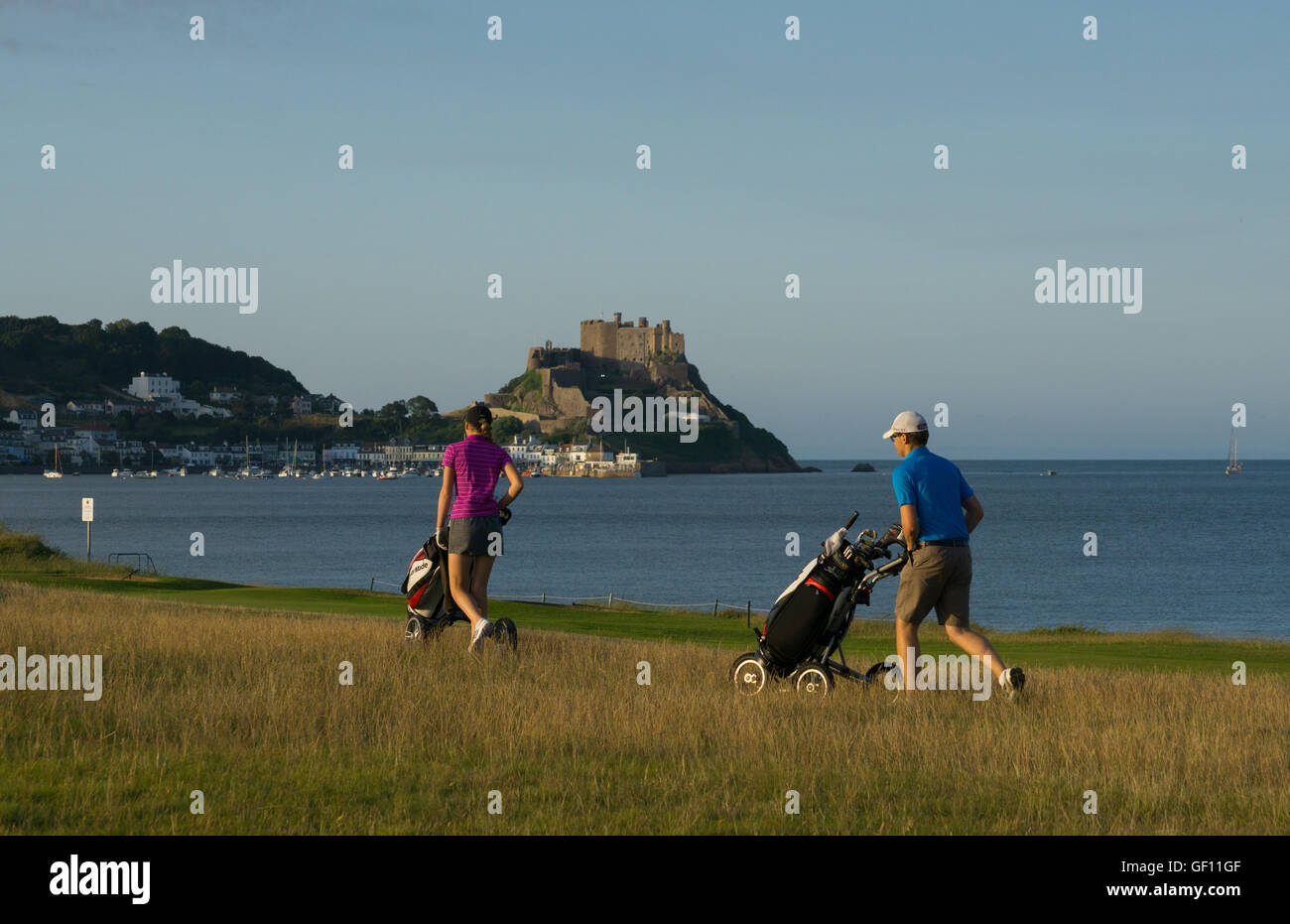 Gorey Castle in the background as two golfers play a round of golf. Stock Photo