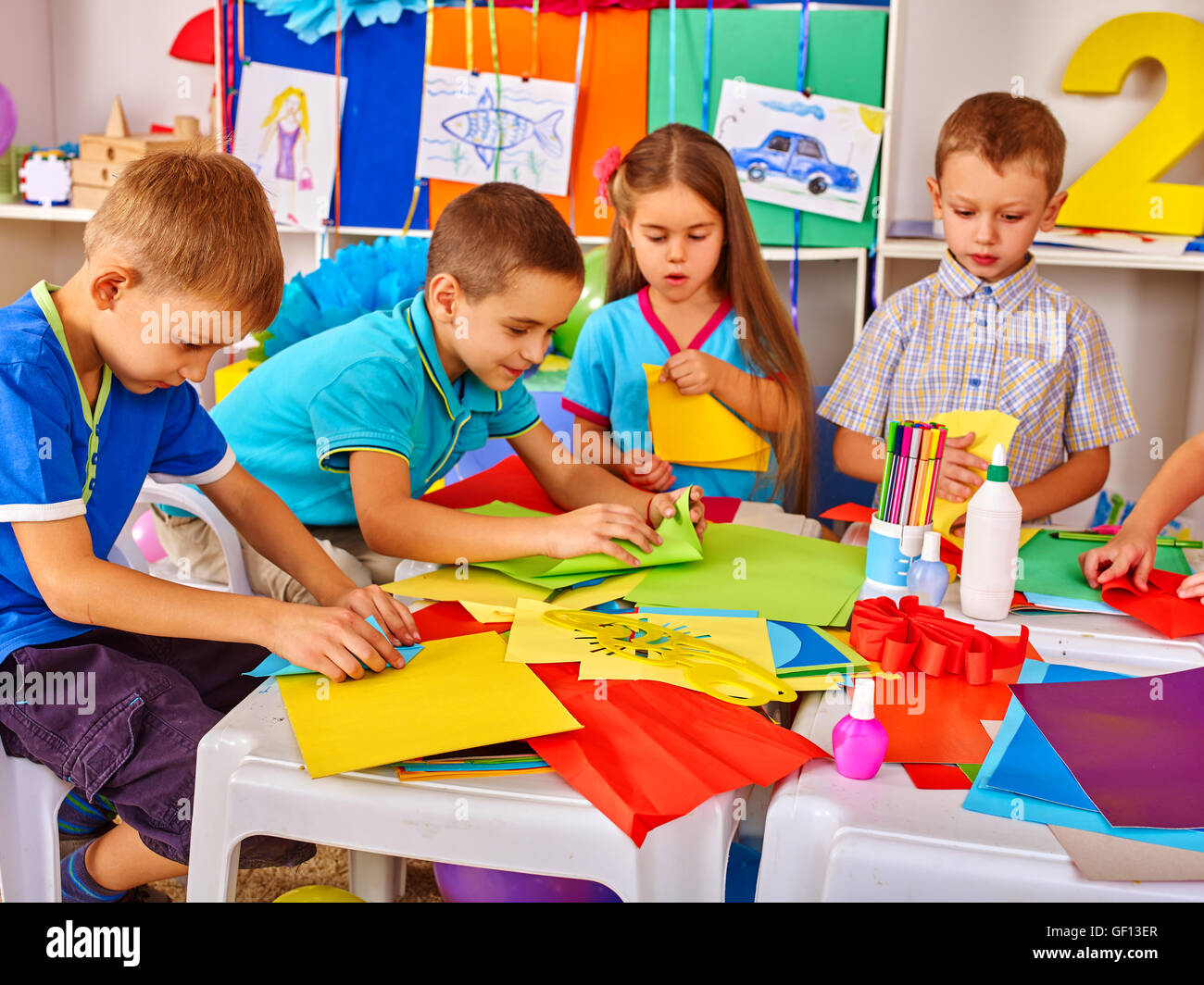 Child Using Paper Children are making something out of colored paper Stock Photo - Alamy