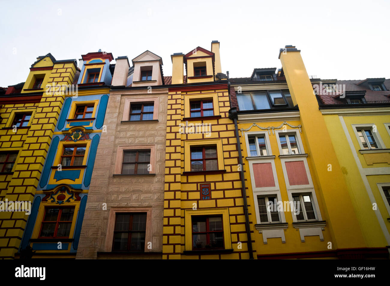Tall, narrow houses with colourful facades line a street near the centre of Wroclaw, Poland. Stock Photo
