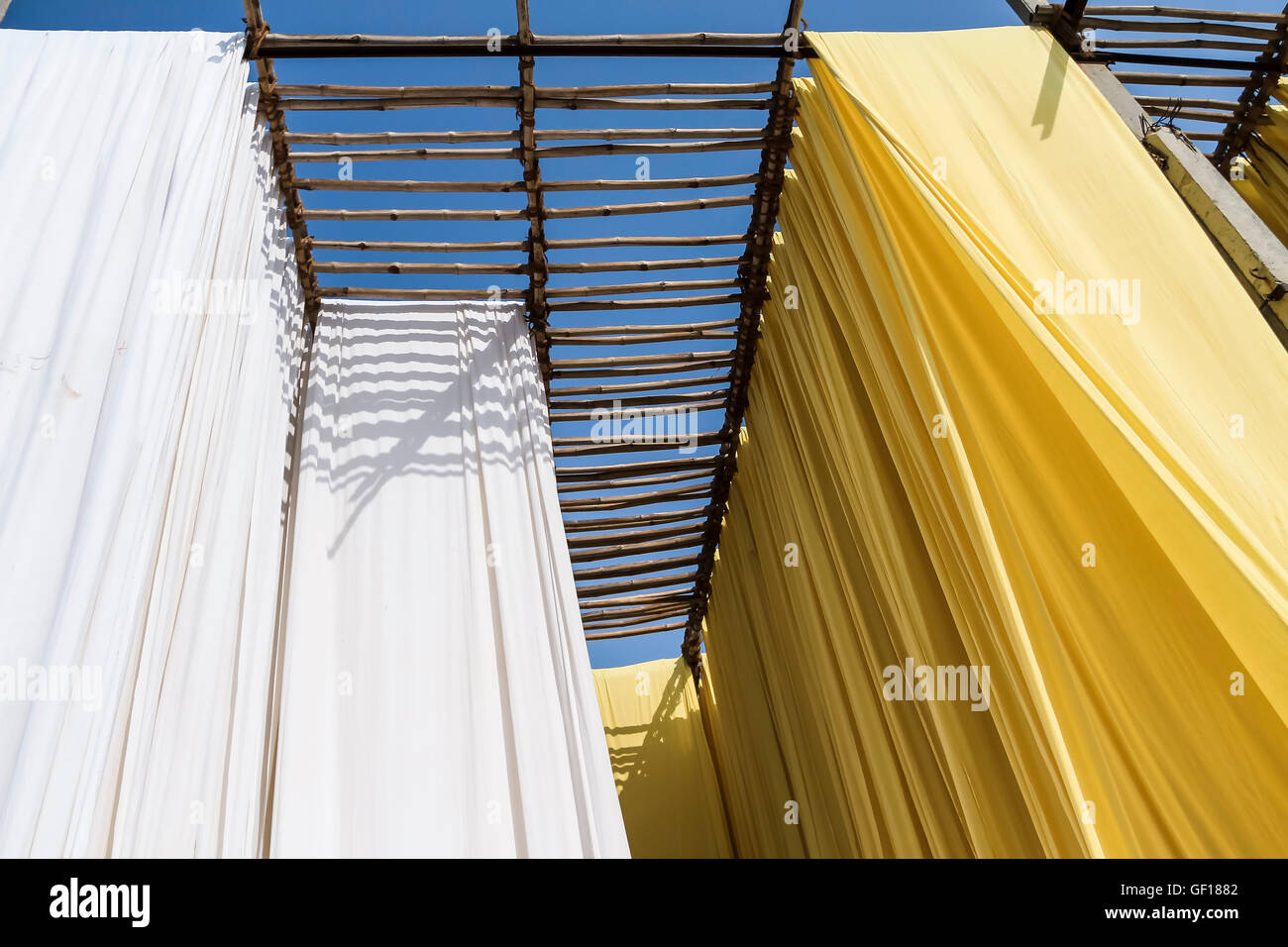 Racks of dyed fabric hanging to dry Stock Photo Alamy