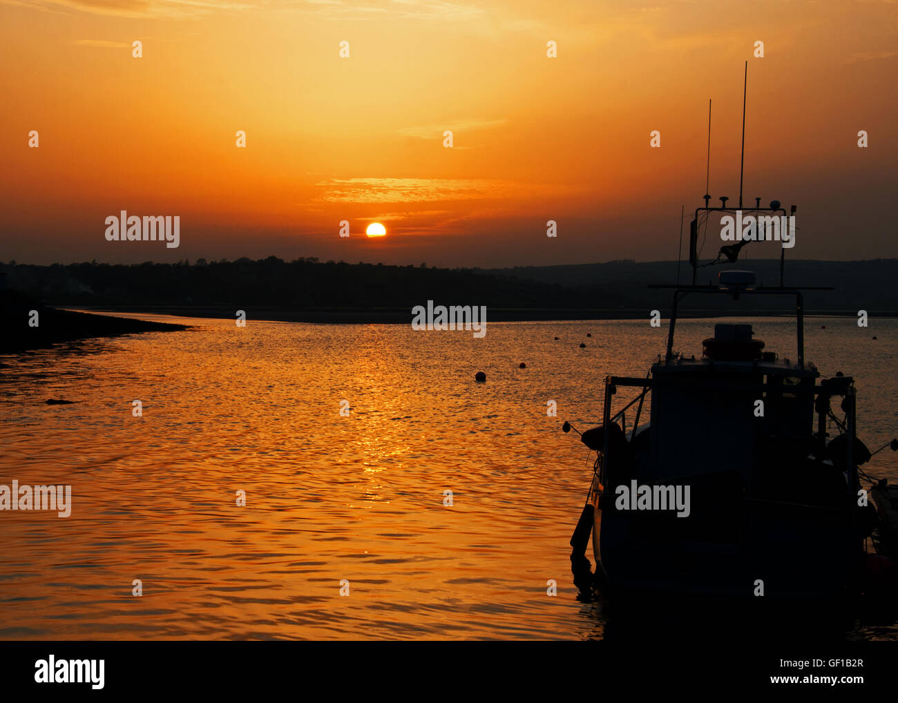 Fishing boat in Courtmacsherry Harbour, West Cork, Ireland at sunset
