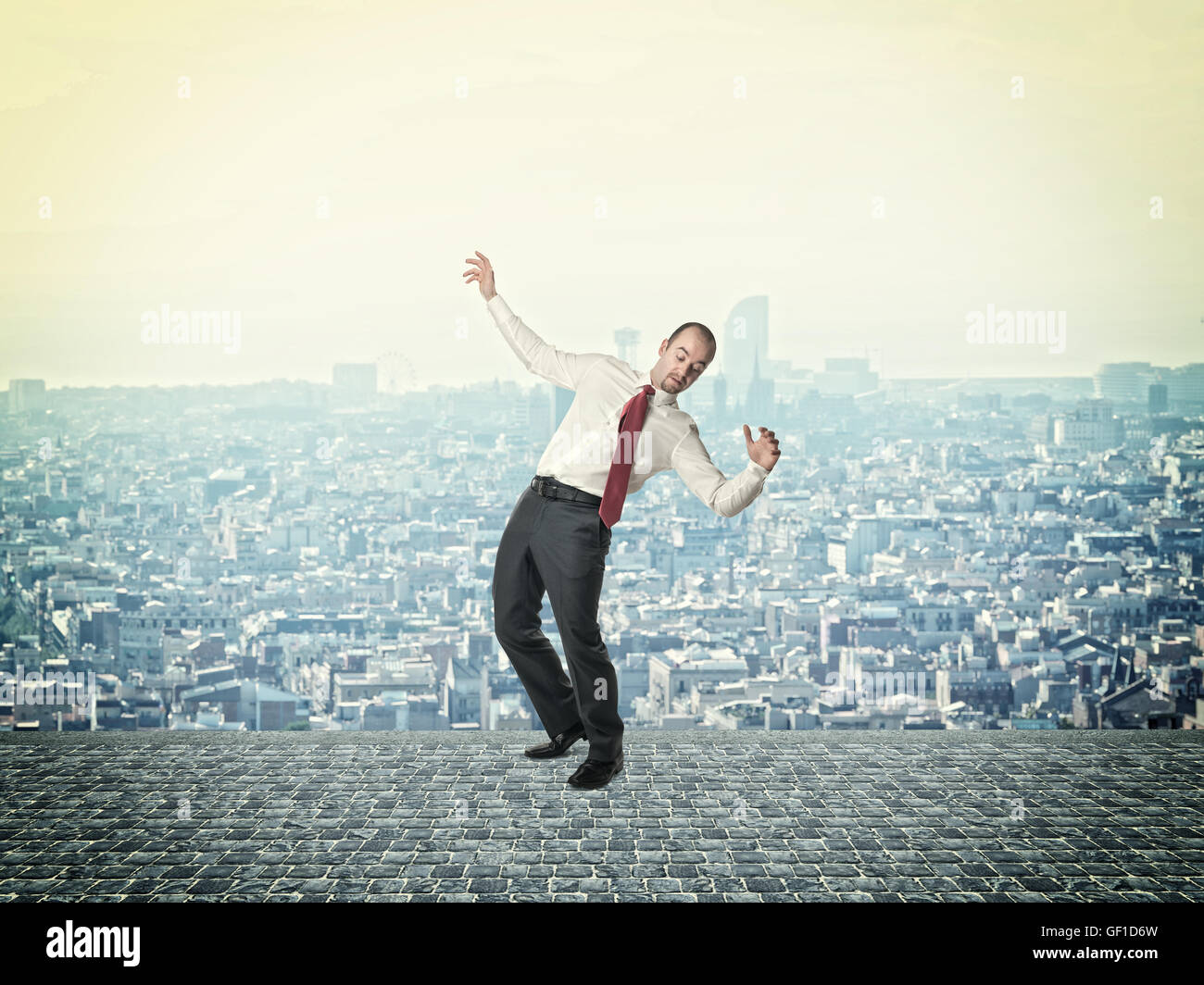 businessman in balance pose urban town background Stock Photo