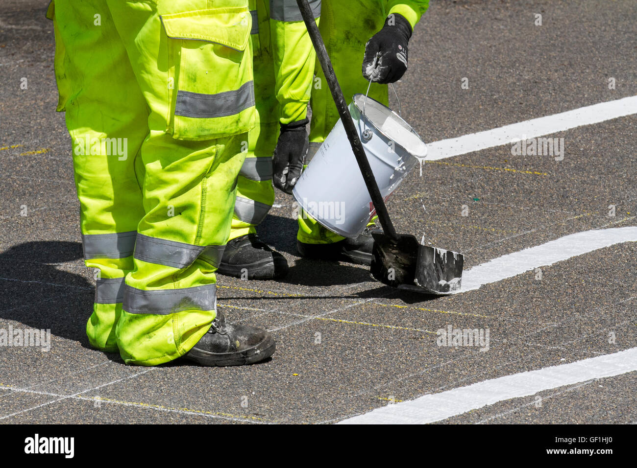 City Council maintenance roadworkers paint white lines on streets. Chapter 8 Traffic Management systems in place on major long-term road works and temporary traffic lights & signs on Preston arterial road, B5253 Flensburg Way in Farington Moss, Lancashire, UK. Stock Photo